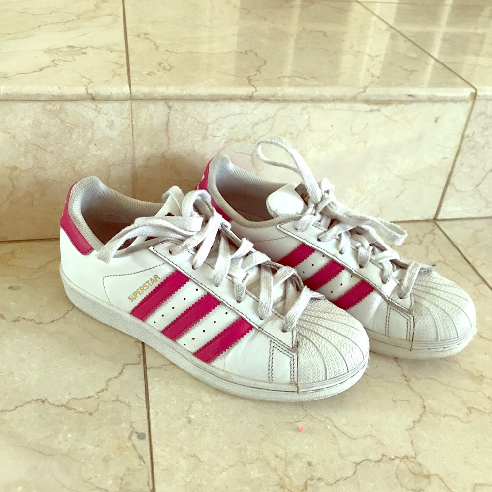 Adidas Superstars with pink stripes